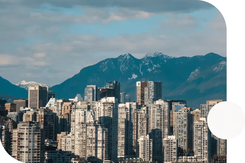 Skyscrapers-in-the-downtown-Vancouver-British-Columbia-skyline-against-the-backdrop-of-a-mountain-range-on-a-cloudy-day