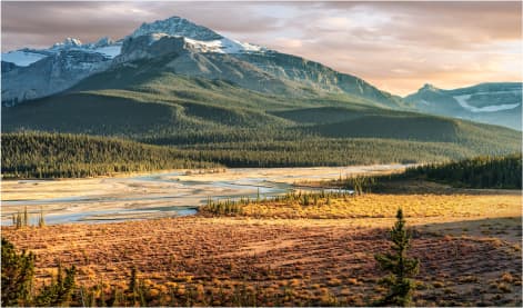Saskatchewan's breathtaking view of the Canadian Rockies, featuring majestic mountains and a serene river, embodying the tranquility and beauty safeguarded by tenant insurance
