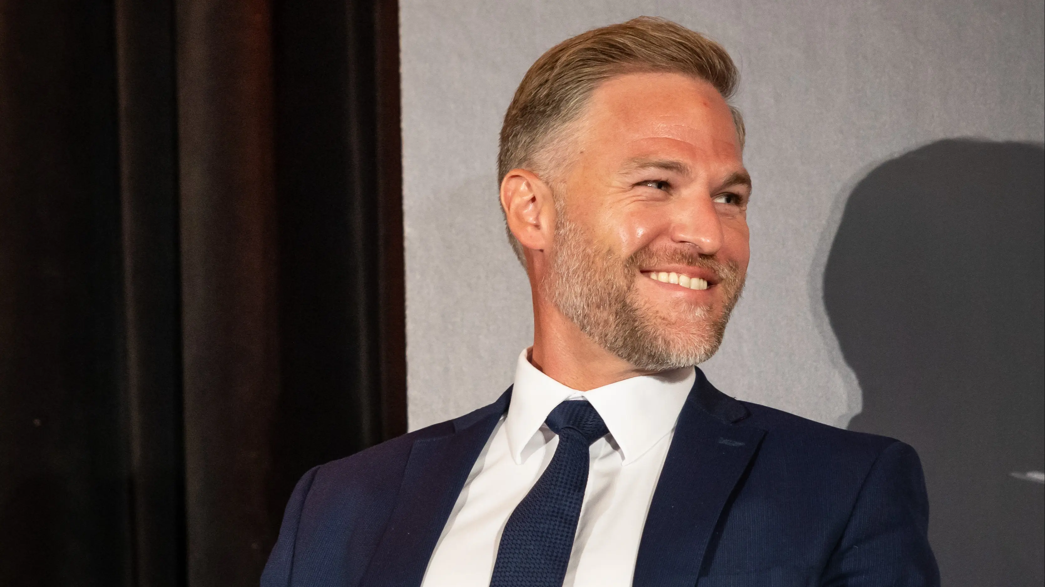 Jeff McCann, CEO of APOLLO Insurance, on stage, speaking in a panel interview at the CAIC.