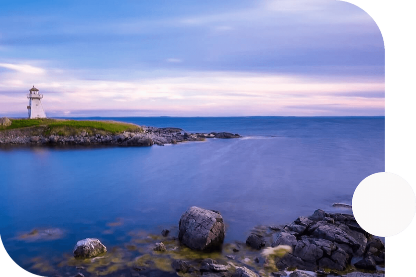 Atlantic-Ocean-view-from-the-shore-with-a-nearby-island-containing-a-quaint-lighthouse-on-a-cloudy-day