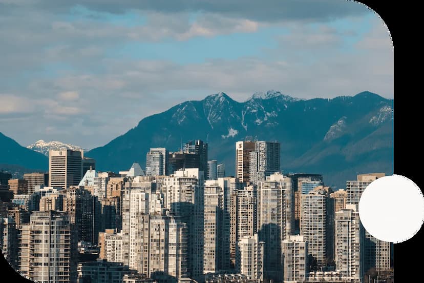 Skyscrapers-in-the-downtown-Vancouver-British-Columbia-skyline-against-the-backdrop-of-a-mountain-range-on-a-cloudy-day